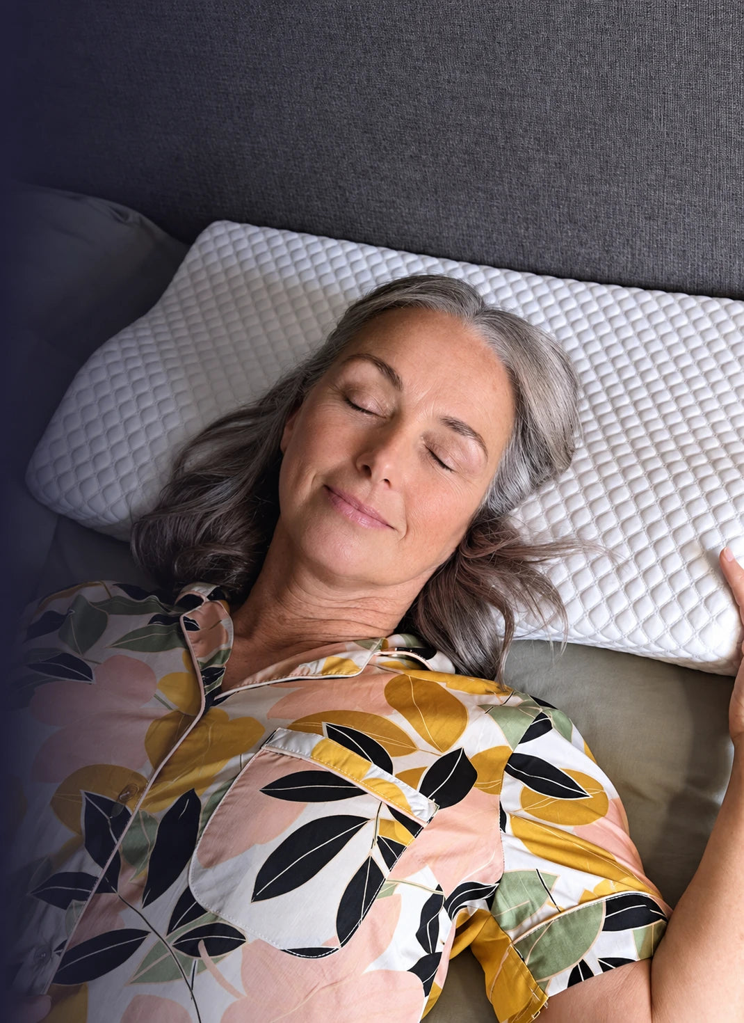 Woman sleeping on her back with her head and neck resting on a contoured pillow